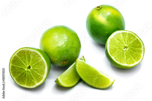Group of whole, sliced lime and halves isolated on white background.