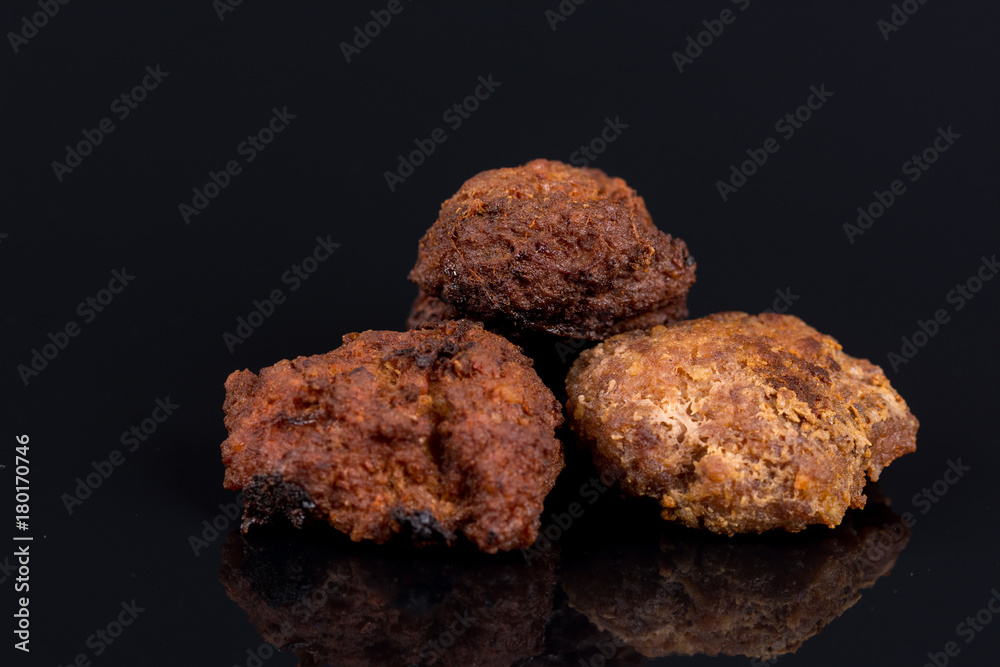 Meatballs isolated above black background with reflections and copy space Meatballs isolated above black background with reflections and copy space