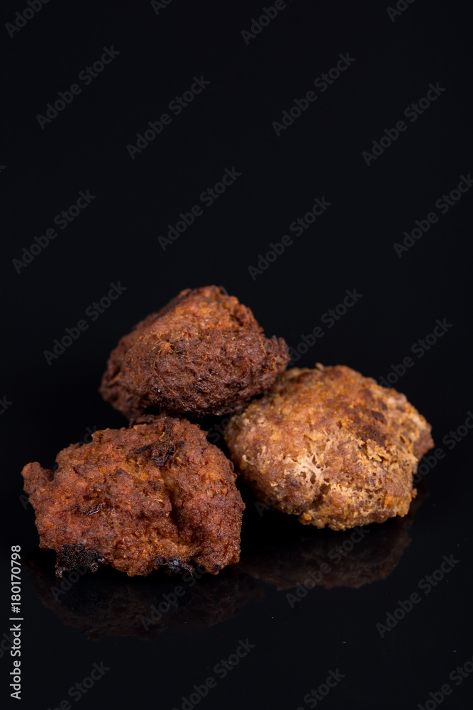 Meatballs isolated above black background with reflections and copy space Meatballs isolated above black background with reflections and copy space