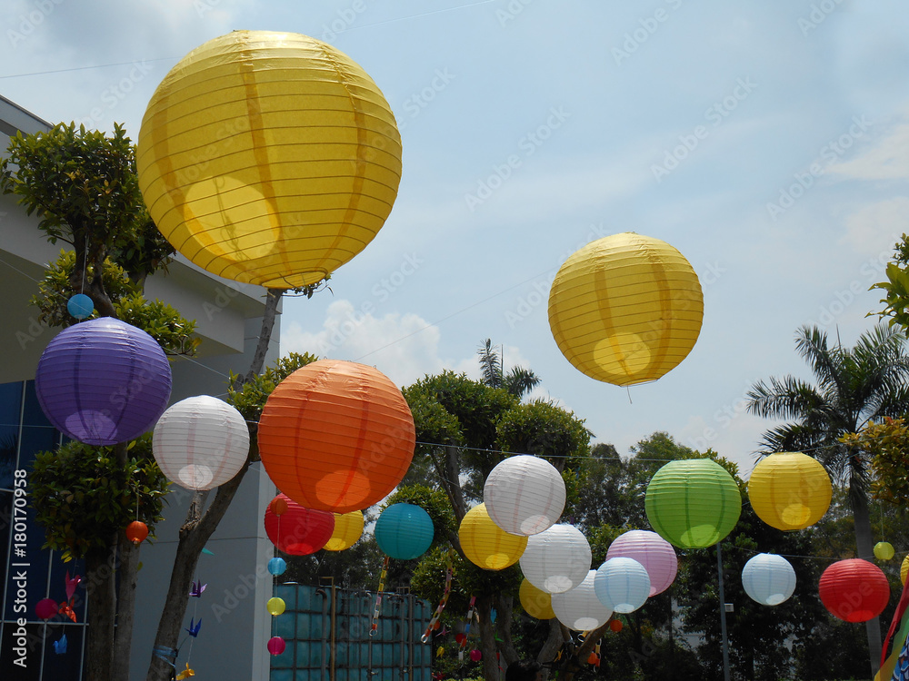 Colorful Japanese paper lanterns or tanglung hang outdoor at the park  during daytime. Stock Photo | Adobe Stock