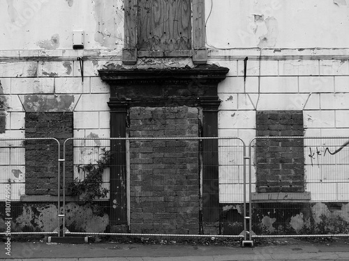 derelict abandoned house on the street awaiting demolition with barriers in wakefield yorkshire englend photo