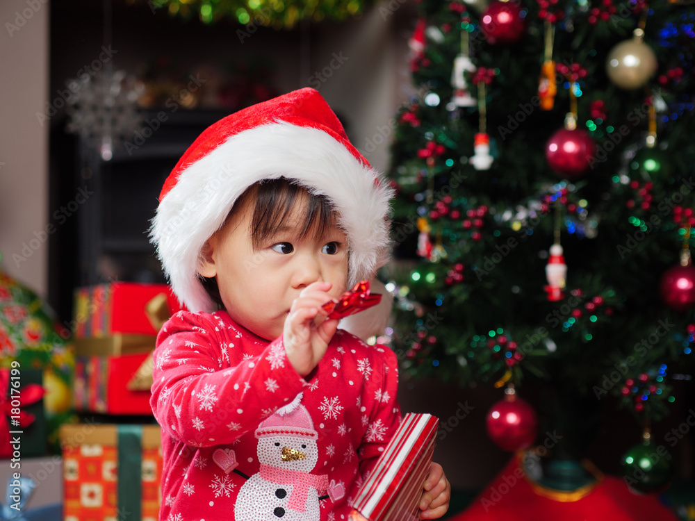 baby girl decorating Christmas tree baby girl decorating Christmas tree