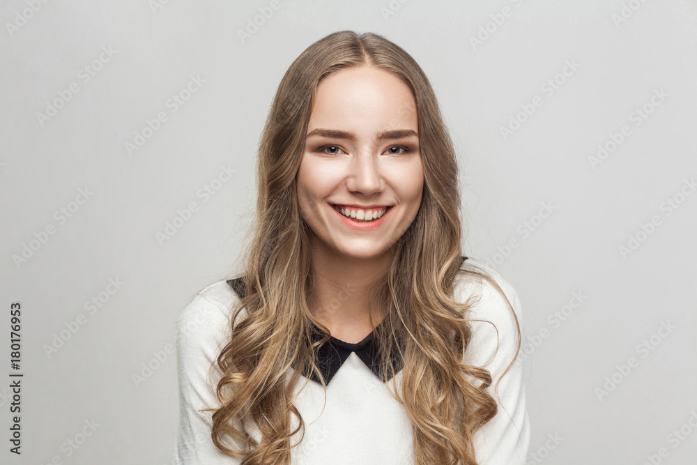 Businesswoman toothy smiling and looking at camera.