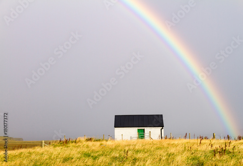 Rainbow over small house
