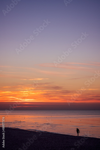 Lonely man walking on the sea beach at sunset © Pav-Pro Photography 