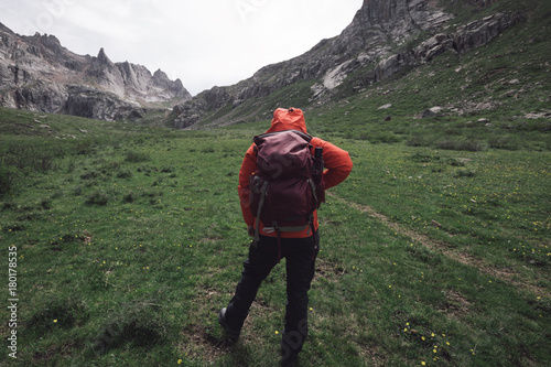 female adventurer hiking on high altitude mountain . photo