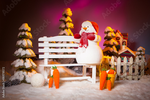 Snowman on a bench. A snowm...
