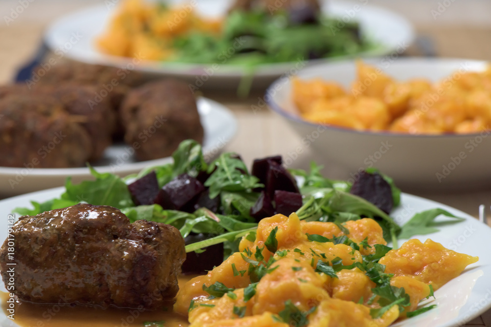 Healthy dish - roast beef roulade, carrot dumplings and rucola salad with red beetroot Healthy dish - roast beef roulade, carrot dumplings and rucola salad with red beetroot