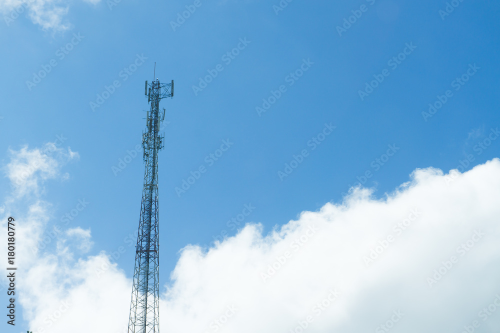 Mobile phone transmitter pole on blue sky and clouds