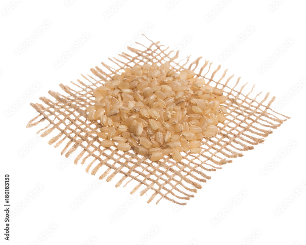 Chinese White Rice. Grains over hessian fabric, isolated white background. Chinese White Rice. Grains over hessian fabric, isolated white background.
