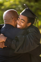 Father hugging his son at his graduation.
