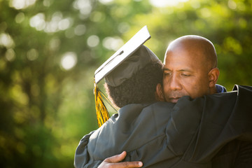 Father hugging his son at his graduation.