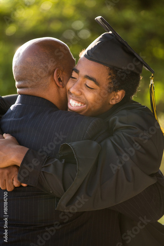 Принти на полотні Father hugging his son at his graduation.