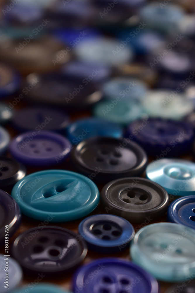 blue sewing buttens on a wood table blue sewing buttens on a wood table