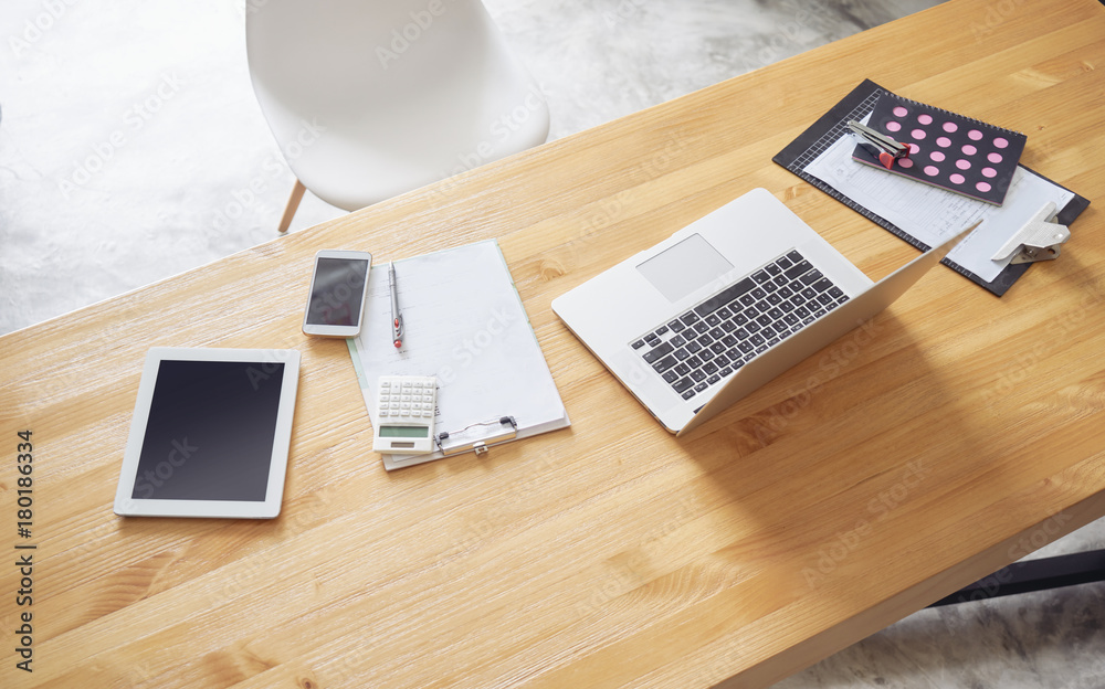 Top angle view of empty workspace office with laptop,digital tablet,smartphone,calculator,note and pen.