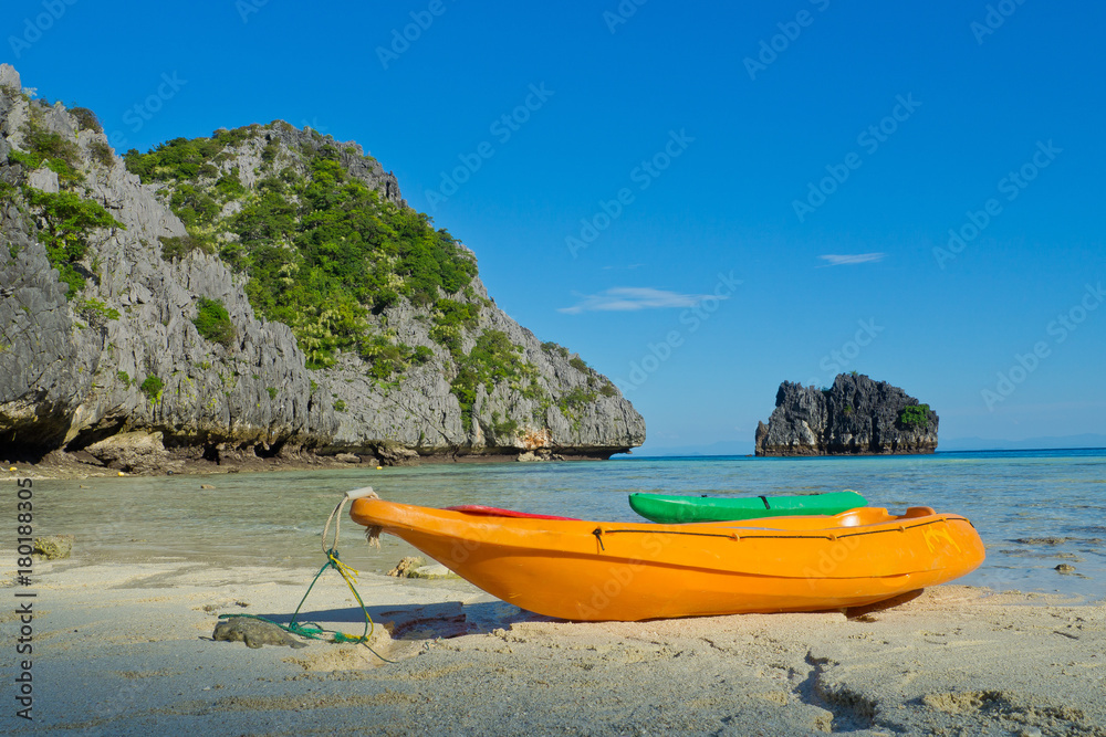 Fototapeta premium beach and sea with Kayak boat. beautiful beach and sea with mountain background. Clear sea. Summer time. Relax on holidays. Travel
