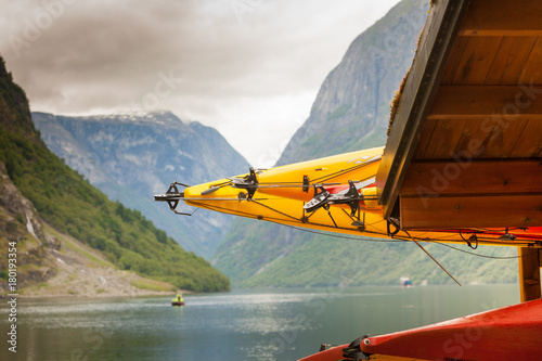 Many canoes on norwegian fjord shore
