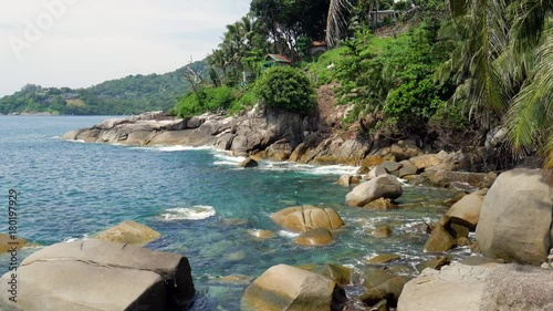 Stones at the coast in the sea. A view to the sea and big stones at the tropical shore in a sunny day.