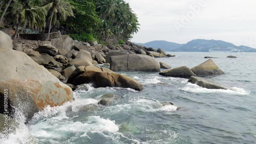 Stones on the tropical coast. View to beautiful sea and big stones at the tropical beach.