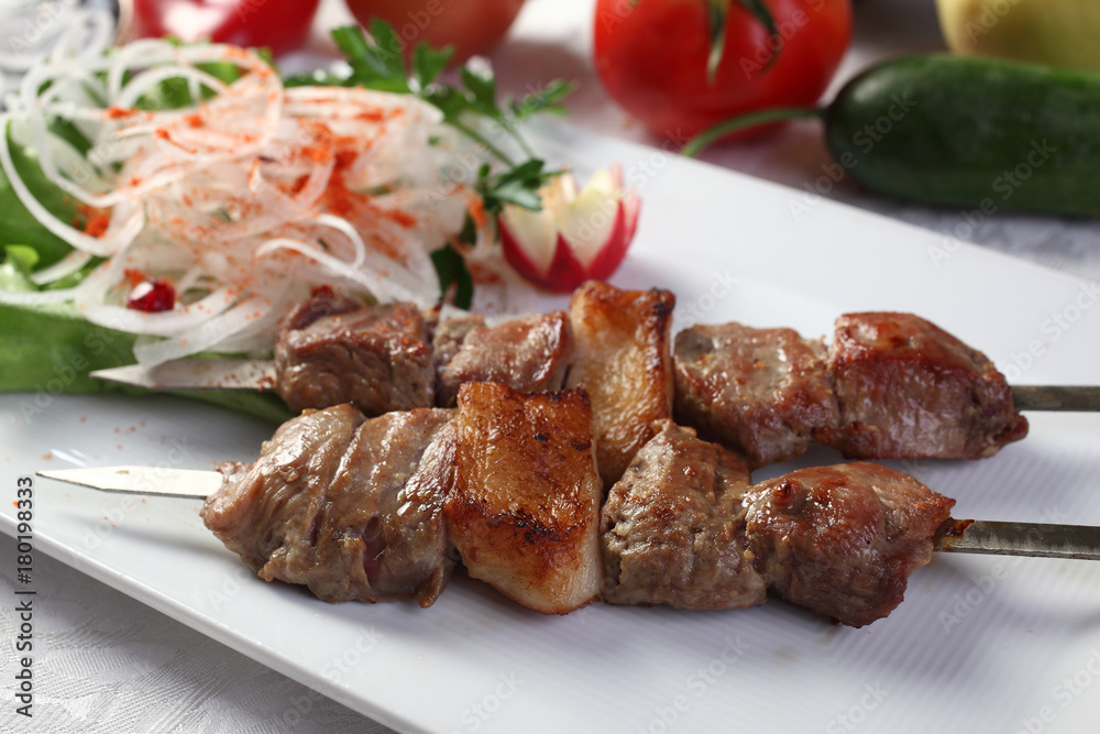Kebab-Chupan.Intercostal portion of meat marinated in dry white wine,fat-tail,ground black pepper,spices.Served with chopped onion and greens.Uzbek cuisine.