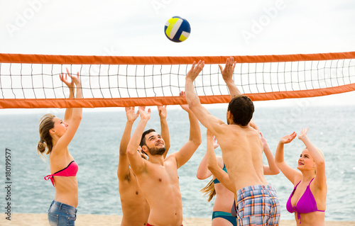 Positive people playing beach volley