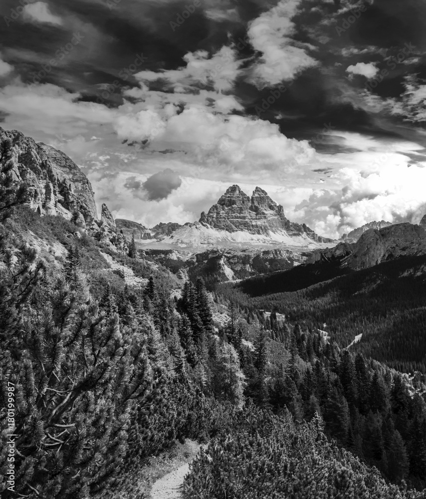Dynamic surreal clouds running over the Tre Cime di Lavaredo, in the Italian Alps black and white