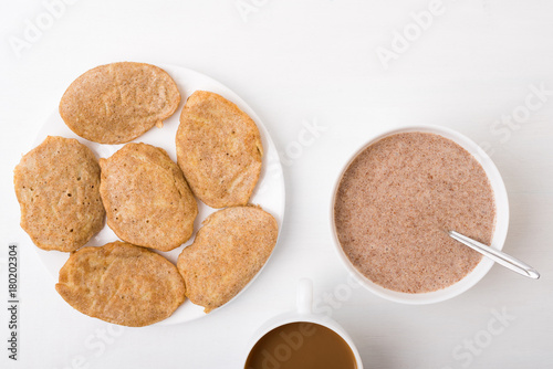 Fritters, coffee and flax-seed porridge on white