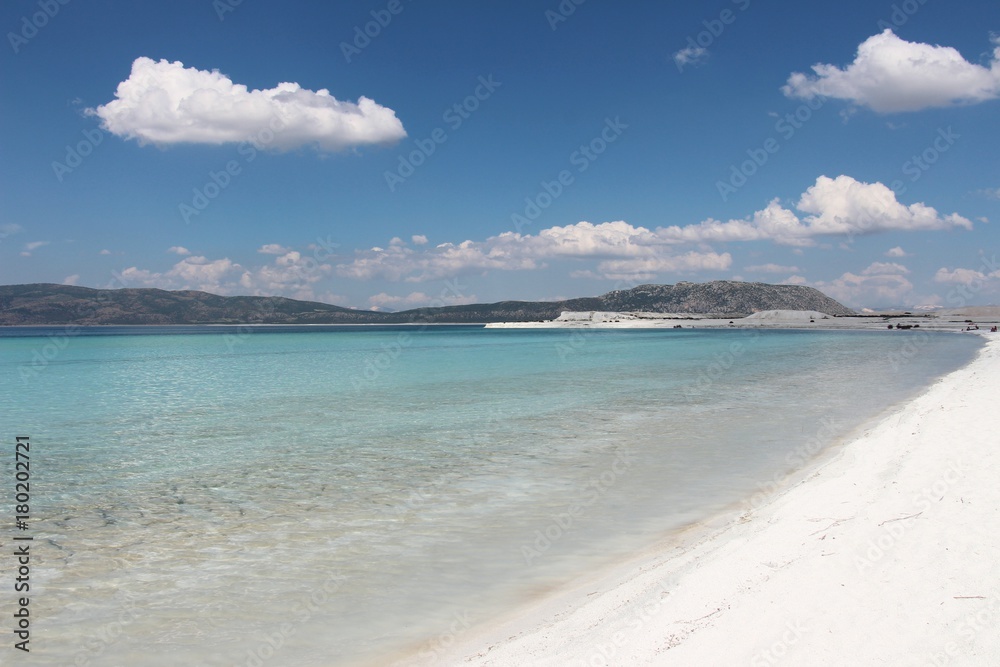 beautiful blue lake and peaceful white sandy beach in sunny day