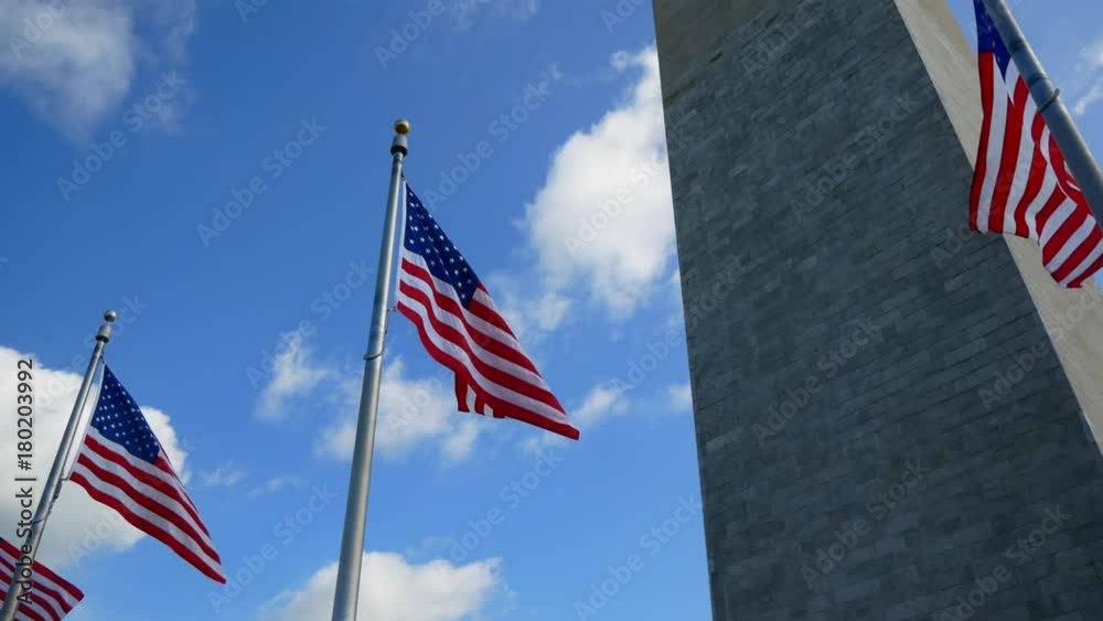 WASHINGTON, DC - OCT 2017: American Flags against Washington Monument in Washington DC WASHINGTON, DC - OCT 2017: American Flags against Washington Monument in Washington DC