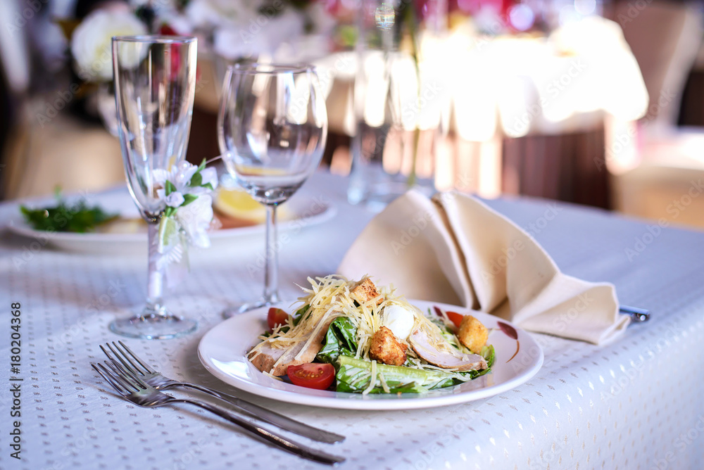 Caesar salad on the holiday table Caesar salad on the holiday table