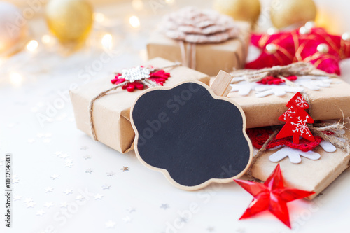 Christmas and New Year background with cloud chalkboard, presents and decorations for Christmas tree. Holiday background with stars confetti and light bulbs. Place for text.