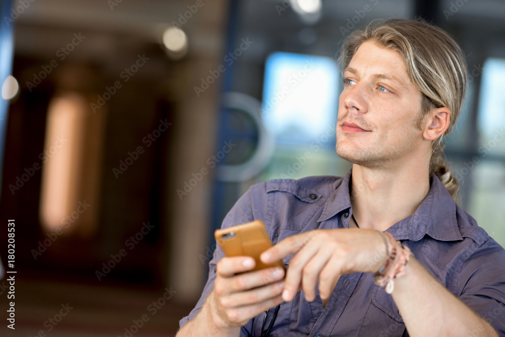 Confident young man in smart casual wear holding phone Confident young man in smart casual wear holding phone