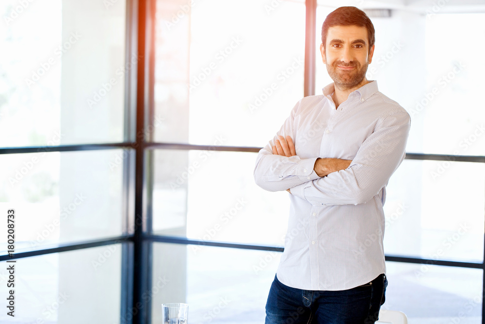 Young caucasian businessman standing in office Young caucasian businessman standing in office