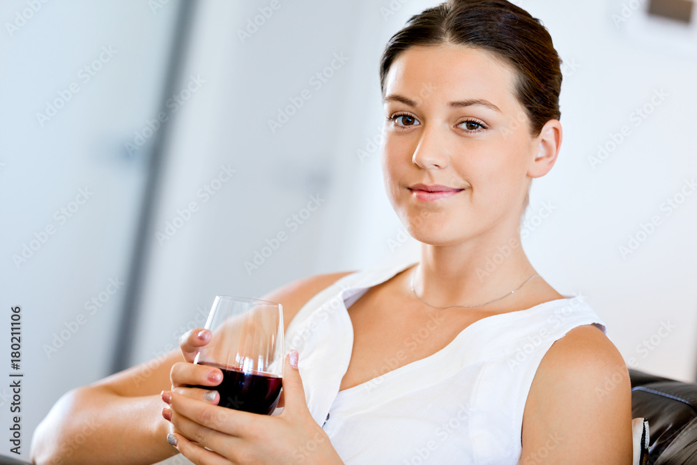 Beautiful young woman holding glass with red wine Beautiful young woman holding glass with red wine