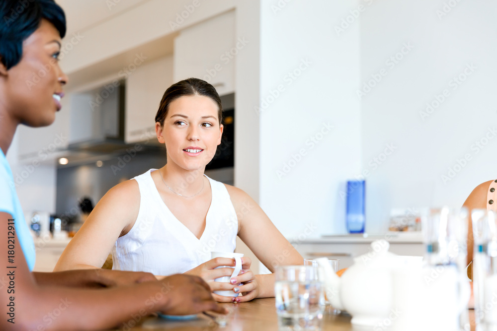 Happy friends talking and drinking coffee and tea Happy friends talking and drinking coffee and tea