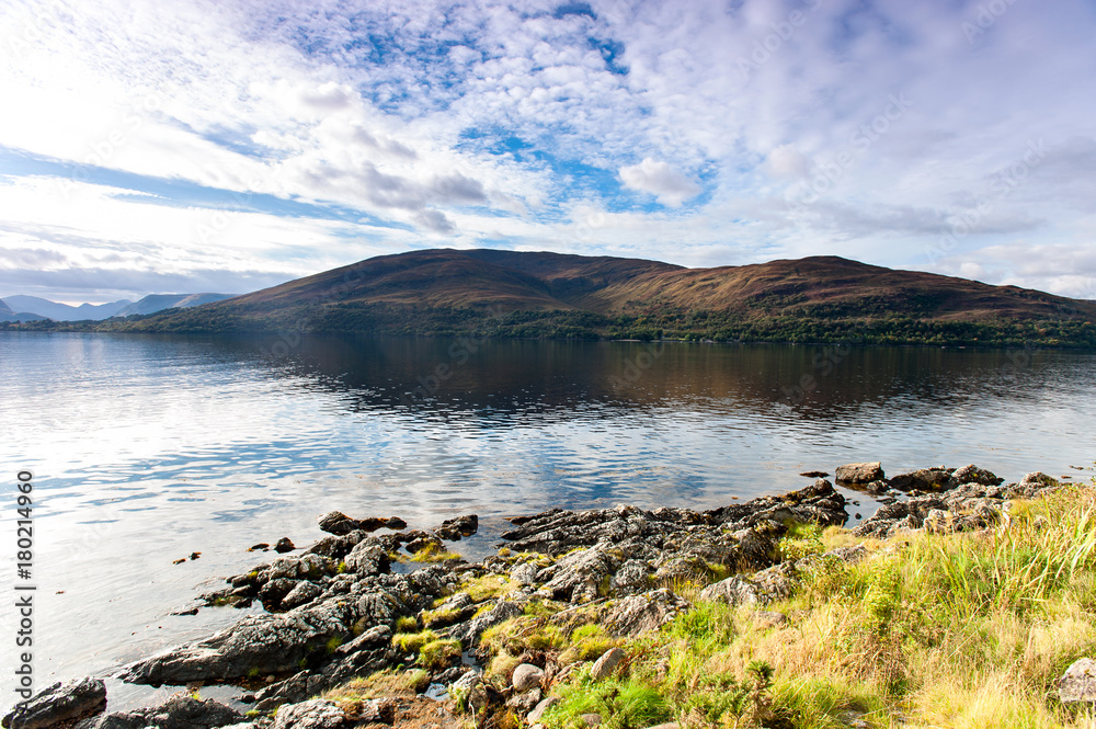 Landscape with beautiful scottish wild mountains and lake with reflection