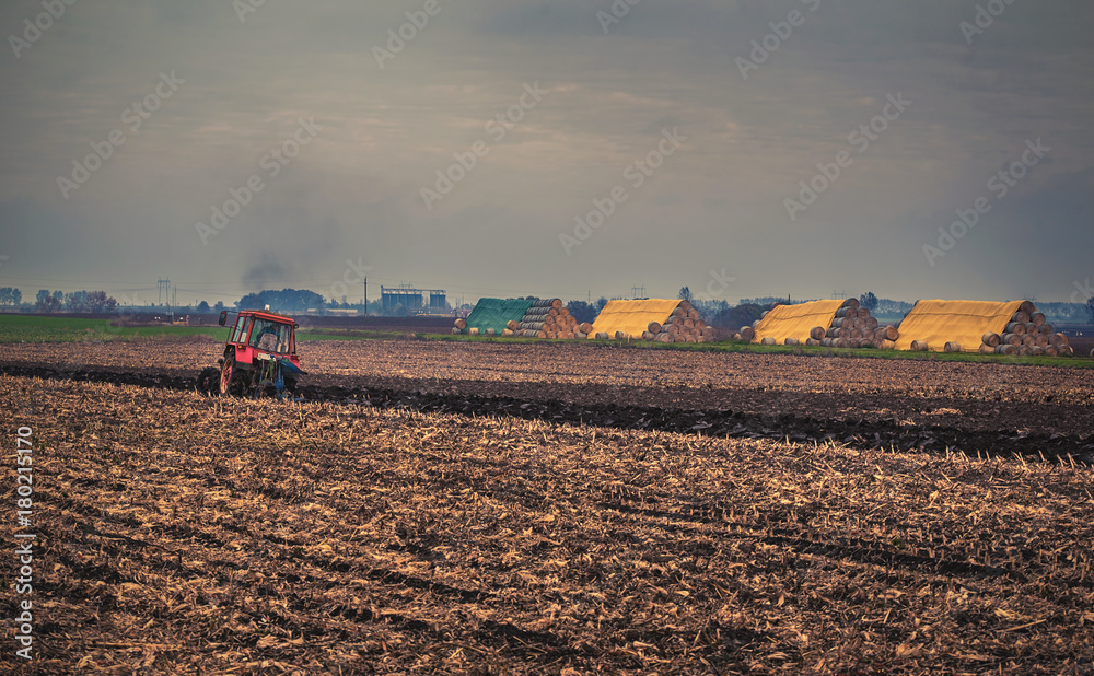 Fototapeta premium Farmer in tractor preparing land