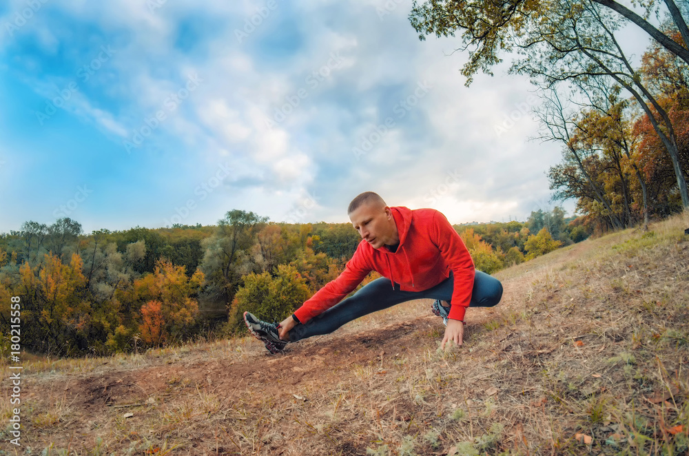 caucasian jogger man performs warming-up caucasian jogger man performs warming-up