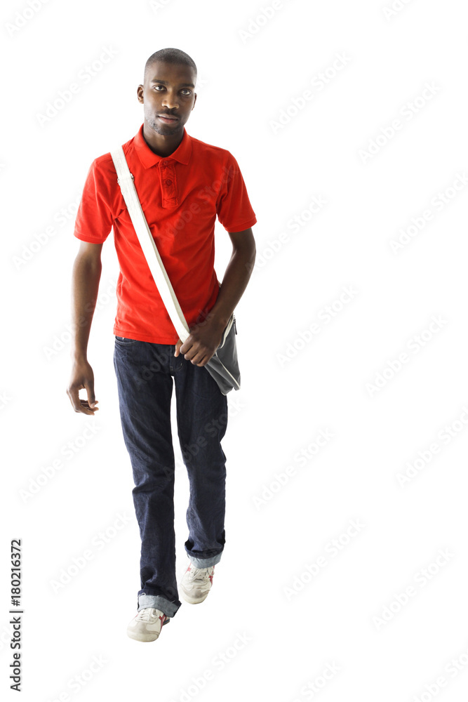 Fototapeta premium African male wearing a red shirt, denim jeans and has a shoulder walking.