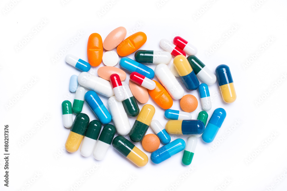 colored pills and capsule on white background
