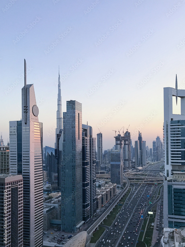 Fototapeta premium Beautiful sunset aerial view to futuristic city buildings and infrastructure