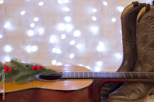Country music christmas background with guitar and cowboy shoes