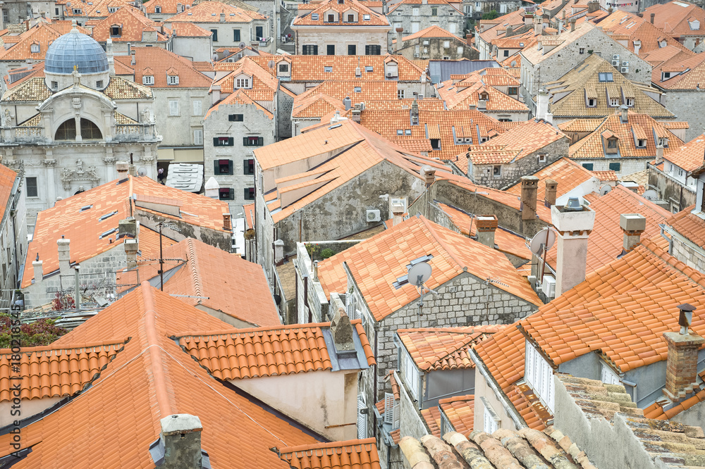 Terra cotta roof tiles fill the frame in a scenic view of the center of the old walled city of Dubrovnik, Croatia