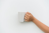 White coffee cup in hand on white background