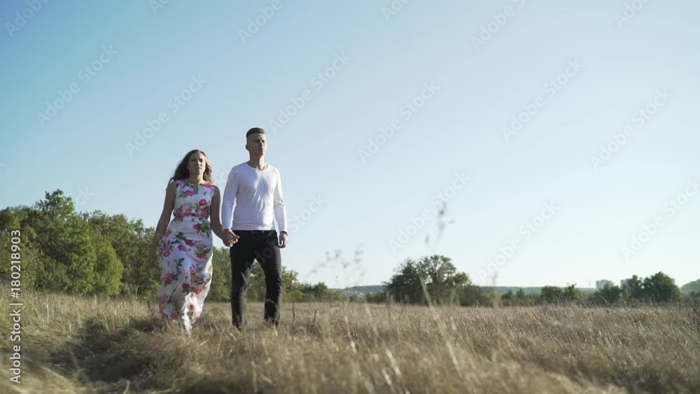 Young couple walking on the field Young couple walking on the field