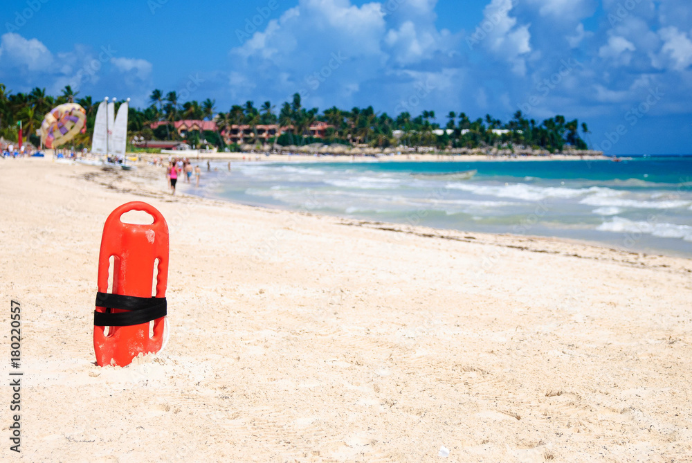 Red plastic buoy for a lifeguard ready to save people on beach Red plastic buoy for a lifeguard ready to save people on beach