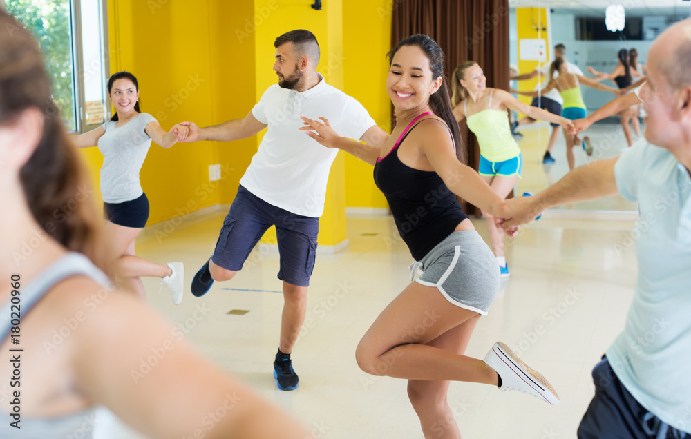 Fototapeta premium Dancing couples enjoying active swing