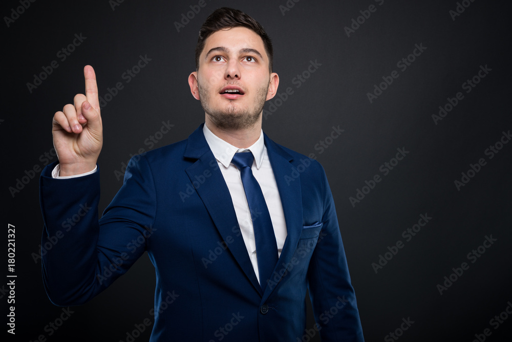 Attractive businessman pointing upwards his idea
