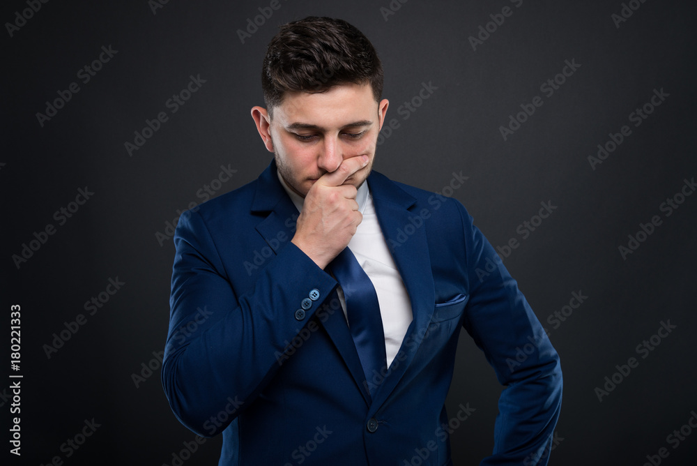 Businessman in formalwear sitting in pensive mood Businessman in formalwear sitting in pensive mood