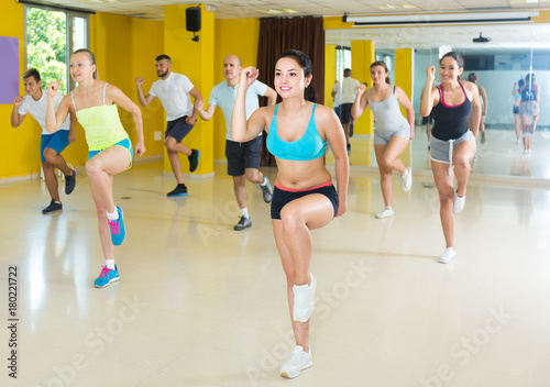 slim athletic women and men dancing strip plastic in class